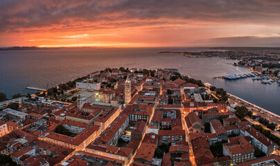 Zadar, Croatia - Aerial panoramic view of the Old Town of Zadar with Cathedral of St. Anastasia, Church of St. Donatus, yacht marina and a dramatic golden summer sunset at background