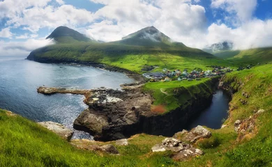 Papier peint photo  Village of Gjogv on Faroe Islands with colourful houses. Mountain landscape with ocean coast  © TTstudio