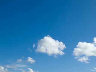 Single white fluffy cumulus cloud in the blue summer sky