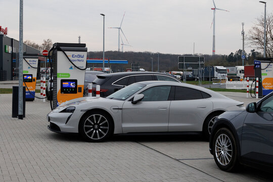 grey Porsche Taycan at an ENBW fast charging station  in Stuttgart, Germany, 21.3.2024
