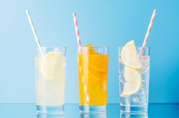 Various lemonade with ice in glasses