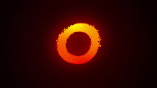 solar eclipse effect with a glowing orange halo on a dark background animation, 4k