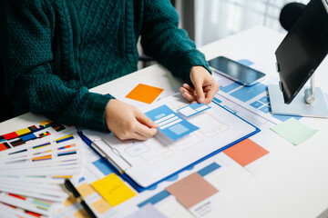  UX developer and ui designer brainstorming about mobile app interface wireframe design with...
