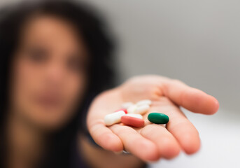 Close up A woman's hand holding a pills - 773808973