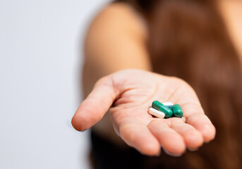 Close up A woman's hand holding a pills - 773808976