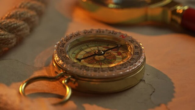 Golden Hour Exploration: Vintage Compass on Antique Map by Seaside