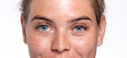 A close up of a person with blue eyes looking at the camera