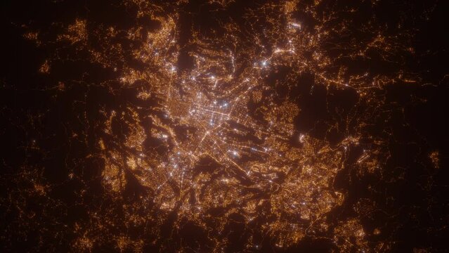 Guatemala (Guatemala) aerial view at night. Top view on modern city with street lights. Camera is zooming out, rotating clockwise. Vertical video. The north is on the left side