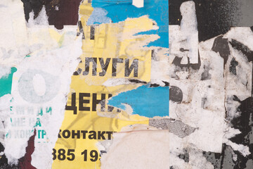 Torn and ripped street poster background, messy and artistic old paper collage backdrop