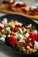 Greek salad with feta cheese, tomatoes, cucumbers, onions and croutons