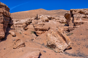 The huge Charyn Canyon in the desert of Kazakhstan. Many chaotic bizarre yellow rocks and blocks in...