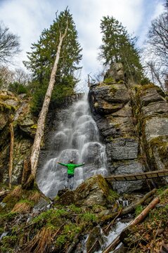 Spring snow melting in the waterfall. Bystre waterfall, Polana mountains, Slovak republic. Hiking theme. Seasonal natural scene. Celebration of pure spring water