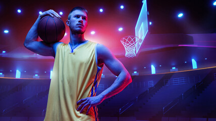 Concentrated basketball player, man in yellow uniform standing with ball against neon colored arena with spotlights. Concept of sport, action, game, competition, tournament, energy. Poster, ad
