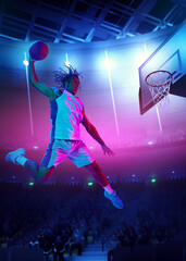 Slam dunk. Competitive young man, basketball player throwing ball into basketball hoop in a jump on...