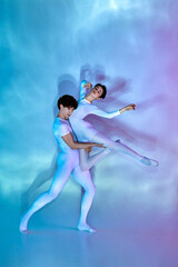 Obraz premium Dynamic portrait of male and female ballet dancers in pastel leotards performing lift against gradient background. Concept of beauty and elegance, dance grace, inspiration, creativity. Ad