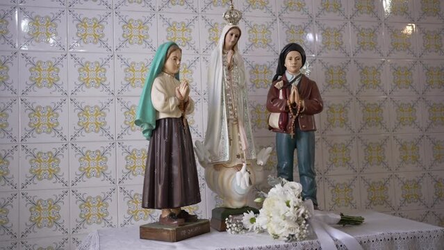 Statues of F&aacute;tima Seers and Our Lady virgin Mary in a church