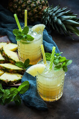 Cold pineapple cocktail with crushed ice and mint, refreshing lemonade drink