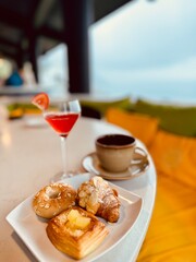 Delicious Temptations, Indulge in a Scrumptious Assortment of Pastries and a Refreshing Beverage in Breakfast