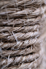 Closeup of coiled twine as an ornament on a pole in a garden