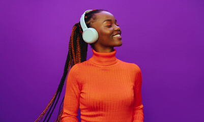 Colorful background with happy woman listening to music on headphones - 773852590