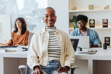 Smiling business woman with glasses in a creative office