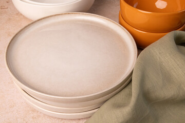 A selection of tableware on a brown stone tabletop.