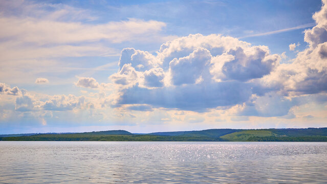 Calm river, hills and shining blue clouds and skies.River Dnestr in Ukraine
