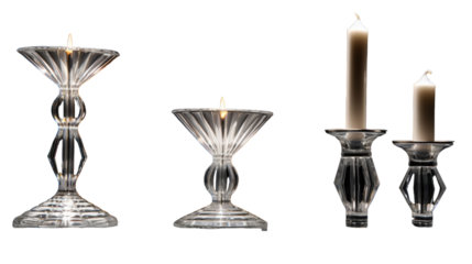 Three candles burn brightly in a row, casting a warm glow in a dimly lit room