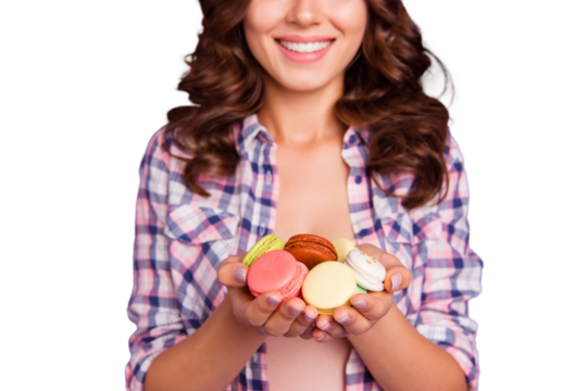 Close-up cropped portrait of nice girlish childish attractive funny wavy-haired lady holding in hands pile colorful sugary macarons isolated over violet pastel background
