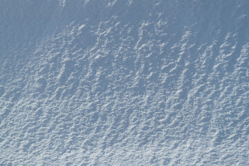 Snow texture. Background of pure blue and white snow. Winter pattern.