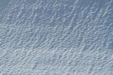 Snow texture. Background of pure blue and white snow. Winter pattern.