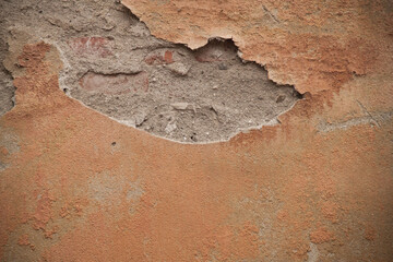 Texture of an old ragged wall. Background of old bricks and cracks in plaster. Yellow and brown...