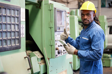 engineer or technician checking and control lathe machine in the factory