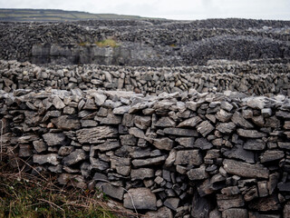 Traditional dry stone fence by a field. Aran islands, county Galway, Ireland. Popular tourist area...