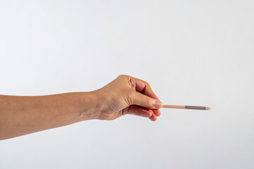 Cosmetic brushes in hand on white background. Set of makeup brushes