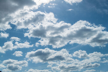 Naklejka na ściany i meble Clouds in the blue sky on a sunny day. Sunny sky background