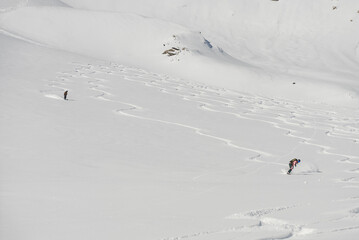 Ski, Snowboard freeride i deep powder snow. Gudauri Georgia Caucasus resort. Freeride in Caucasus mountains. Freeride snowboarding in winter. Heliboarding freeride. Riding in powder on snowborad.