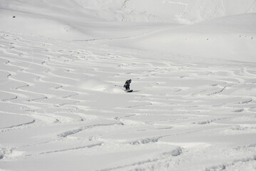 Ski, Snowboard freeride i deep powder snow. Gudauri Georgia Caucasus resort. Freeride in Caucasus mountains. Freeride snowboarding in winter. Heliboarding freeride. Riding in powder on snowborad.