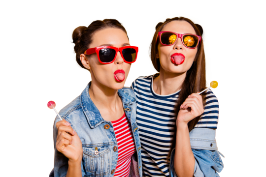 Close up portrait of two nice-looking good-dressed lady glasses spectacles show thumbs up look at camera hold sugar sweet yummy calories caramel confectionery dessert in hands isolated yellow wall - Powered by Adobe