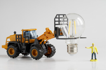 Toy tractor and worker transport and prepare an LED lamp for installation. Transport, loading,...