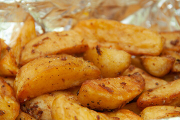 Baked potatoes in foil. Food delivery. Texture of baked potatoes with skin