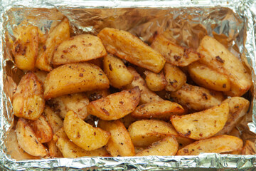 Baked potatoes in foil. Food delivery. Texture of baked potatoes with skin