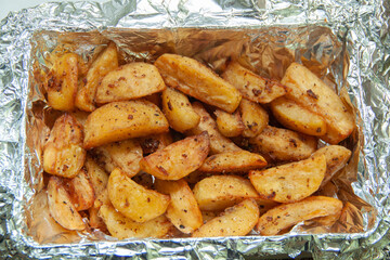 Baked potatoes in foil. Food delivery. Texture of baked potatoes with skin