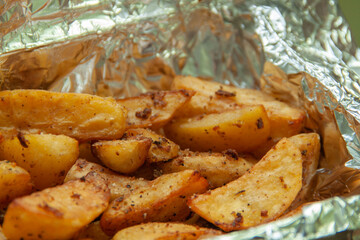 Baked potatoes in foil. Food delivery. Texture of baked potatoes with skin