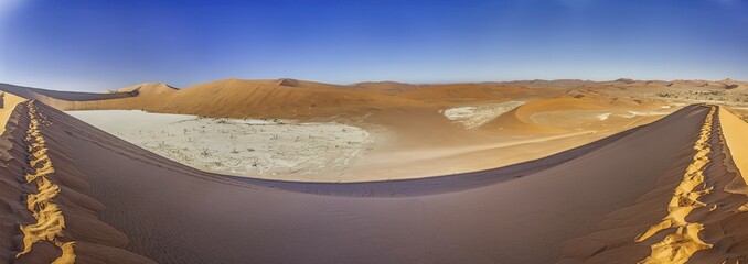 Panoramic view from the Big Daddy Dune in Sussusvlei onto the salt pan of Deathvlei with surrounding red dunes in the morning