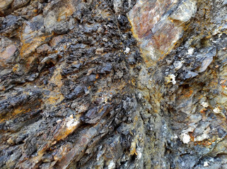 Geodesy. Stone texture. The rock is brown and red. Mineral background. Design from natural materials.