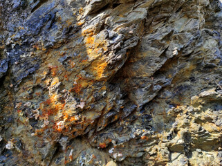 Geodesy. Stone texture. The rock is brown and red. Mineral background. Design from natural materials.