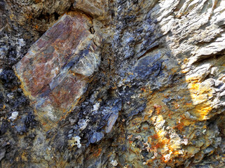 Geodesy. Stone texture. The rock is brown and red. Mineral background. Design from natural materials.
