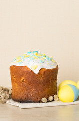 Easter cake with painted eggs on wooden table