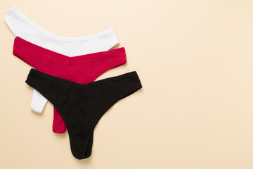 Women's cotton panties on color background, top view